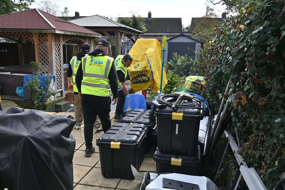 Wish Junk Removal crew loading waste bins at a residential property